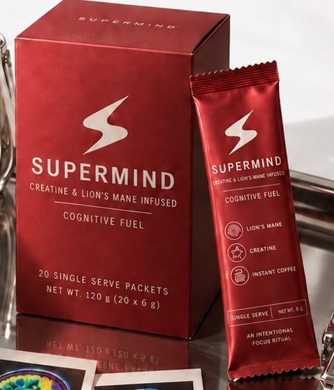 Supermind creatine coffee box and stick pack on a silver tray